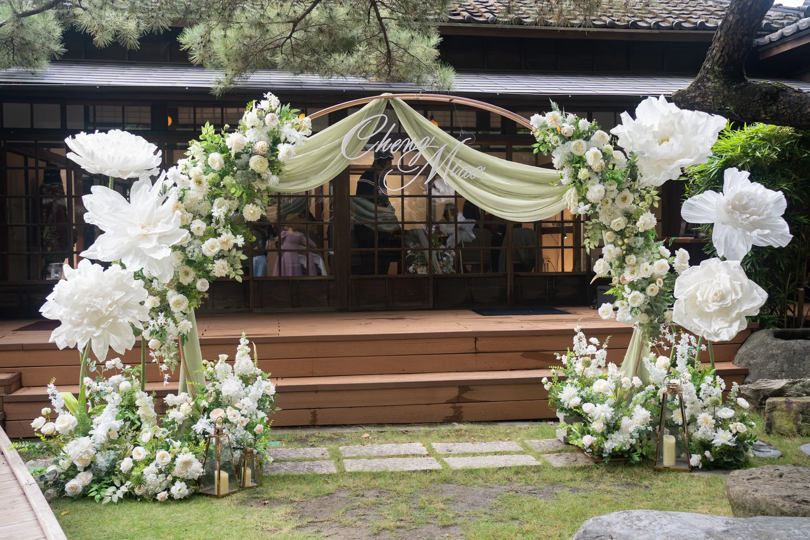 東美園戶外證婚花拱全景:白綠鮮花、淡綠紗幔與木造庭院